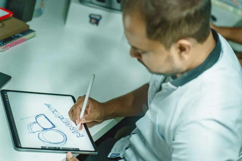 Logo concept sketched with a stylus on a tablet by a Bangladesh logo design specialist